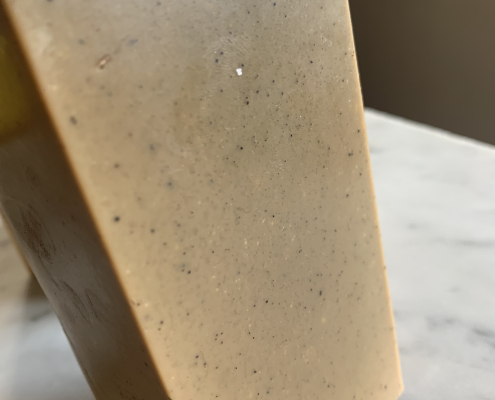 Coffee soap block, fresh out of soap mold. standing vertically on marble slab